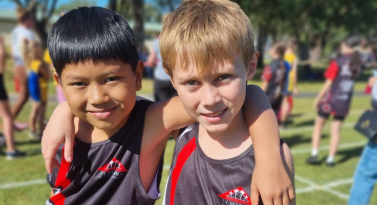 students with arms around each other at sports carnival
